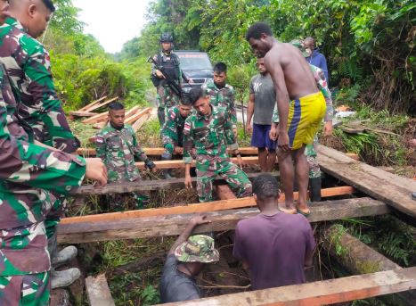 Satgas Pamtas Yonif Raider 142/KJ Gotong Royong Bersama Warga Perbaiki Jembatan Rusak
